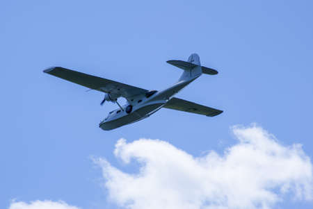 Seaplane in the sky with twisted cloudの写真素材