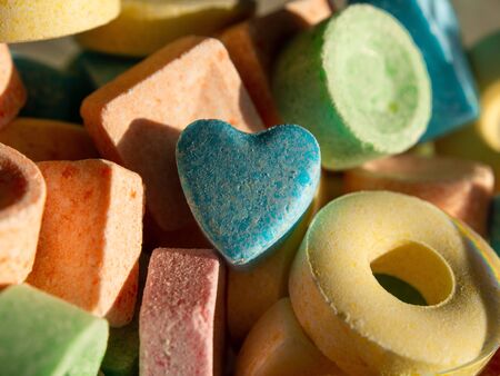 Heap of colorful sweets. Daylight, close-up, pastel colors, geometrical figures, geometrical shapes.