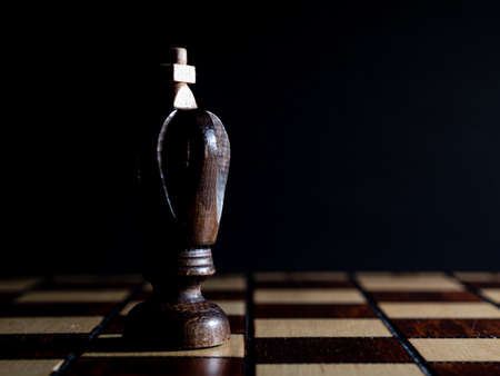 Chess King. A wooden chess piece photographed in a low key style.の写真素材