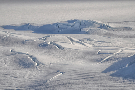 Sunlit cracks in the thick snow near Trolltunga, Norwayの写真素材