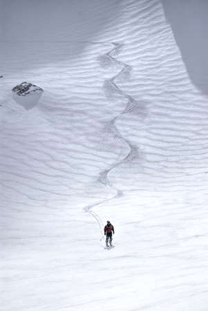 Astonishing view of a skier at the foot of a ski slopeの写真素材