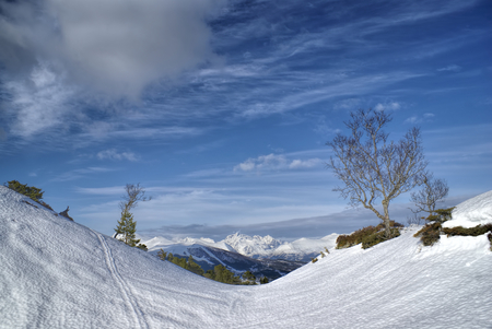 Picturesque view of a snowy valley in Norway with mountains in the backgroundの写真素材