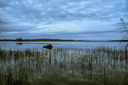 Panoramic view of sky reflected on the surface of a lake in Finlandの写真素材