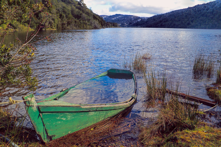 Picturesque view of a boat sinking into a lakeの写真素材