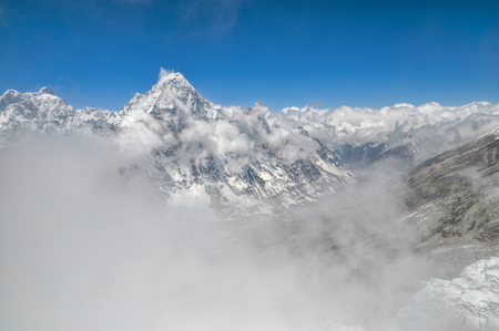 Panoramic view of Kangchenjunga mountains hidden by passing cloudsの写真素材