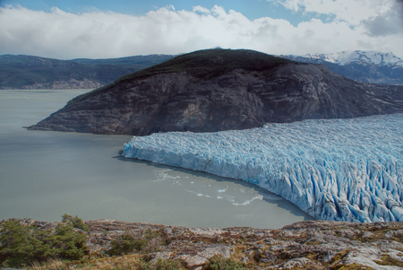 Wrinkled ice wedged between two mountains in Torres del Paine National Parkの写真素材