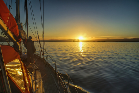 Scenic sunrise viewed from yacht over the coast of Chile in South Americaの写真素材