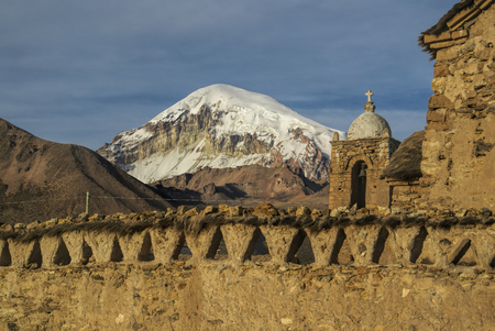 Nevado Sajama, highest peak in Bolivia behind an old church in Sajama national parkの写真素材