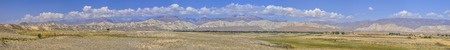 Scenic panorama of green grasslands in Kyrgyzstanの写真素材
