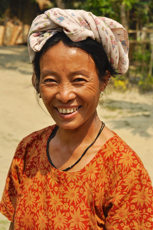 Nagaland, India - March 2012: Joyful woman smiles on camera in Nagaland, remote region of India. Documentary editorial.のeditorial素材