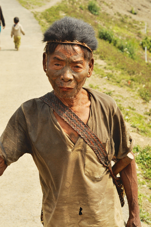 Nagaland, India - March 2012: Elder man with painted face in Nagaland, remote region of India. Documentary editorial.のeditorial素材
