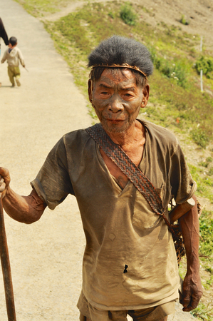 Nagaland, India - March 2012: Elder warrior with painted face in Nagaland, remote region of India. Documentary editorial.のeditorial素材