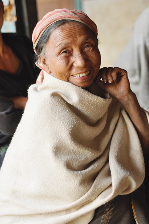 Nagaland, India - March 2012: Happy old woman smiles at camera in Nagaland, remote region of India. Documentary editorial.のeditorial素材