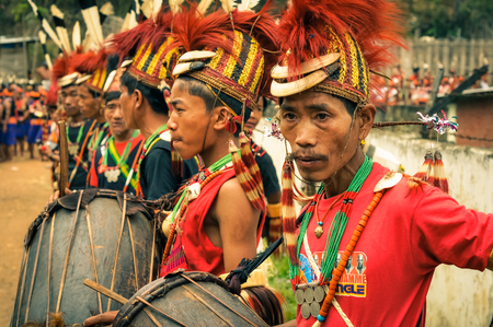 Mon, Nagaland - April 2012: Photo of young boys in traditional costumes and hats standing in row and holding drums during performance at Aoleang festival in Mon, Nagaland. This festival showcases rich cultural heritage of this country. Documentary editoriのeditorial素材