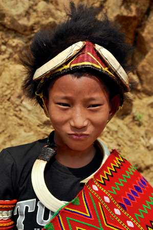 Aoleang, Nagaland, India - April 2012: Confident native boy in traditional warrior costume during Aoleang festival in Aoleang, Nagaland, India. Documentary editorial.のeditorial素材
