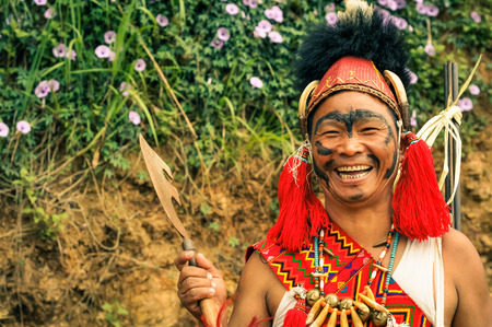Mon, Nagaland - April 2012: Young native man with black colour on his face poses in traditional...