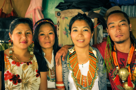 Wanching, Nagaland - April 2012: Four native people with beautiful necklaces made of beads look to photocamera at Aoleang in Wanching, Nagaland. Aoleang is main festival of Konyaks from northern Nagaland. Documentary editorial.のeditorial素材