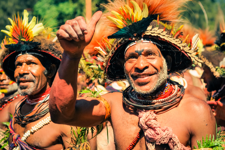 Wabag, Papua New Guinea - circa August 2015: Smiling native half-naked men during traditional Enga cultural show in Wabag, Papua New Guinea. Documentary editorial.のeditorial素材