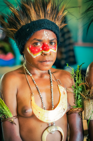 Hagen show, Papua New Guinea - circa August 2015: Young girl during preparation for Hagen show, Papua New Guinea. Documentary editorial.のeditorial素材