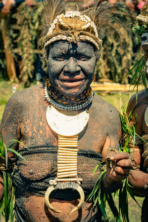 Wabag, Papua New Guinea - circa August 2015: Native half-naked woman during traditional Enga cultural show in Wabag, Papua New Guinea. Documentary editorial.のeditorial素材