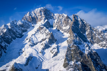 Photo of peaks of mountains covered in snow during winter in Courmayeur in northern Italy.の写真素材