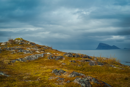 Photo of cliffs with rocks and sea in distance in Sommaroy in Norway.の写真素材