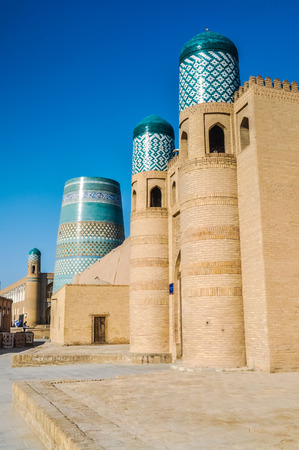 Photo of large building made of bricks with painted blue ornaments in Khiva in Uzbekistan.の写真素材