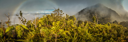 Panoramic photo of mountains covered by fog with rainbow in Digne in Kubor range, Papua New Guinea. In this region, one can only meet people from isolated local tribes.の写真素材