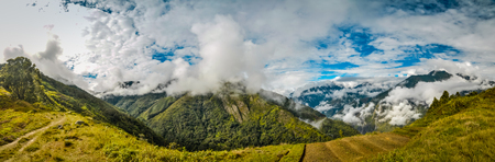 Panoramic view of mountains in morning fog in Dani circuit near Wamena, Papua, Indonesia. In this region, one can only meet people from isolated local tribes.の写真素材