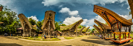 Sulawesi, Indonesia - May 2015: Panoramic photo of tongkonans with saddleback roofs and small square in Kete Kesu, Toraja region in Sulawesi, Indonesia. Documentary editorial.のeditorial素材