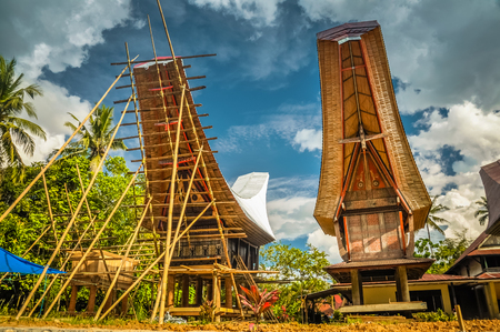 Photo of building up of wooden tongkonan, traditional ancestral house with boat-shaped roof in Lemo, Toraja region in Sulawesi, Indonesia.の写真素材