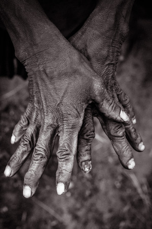 Photo of womans hands with wrinkles marked by time and work in Trikora, Papua, Indonesia.の写真素材