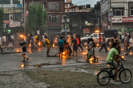 Nepal - circa May 2012: People walk on street and hold burning torches during Nepal general strike. Documentary editorial.の写真素材