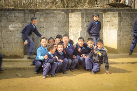 Ziro, Arunachal Pradesh - circa March 2012: Young boys pose in school uniforms near their school in Ziro, Arunachal Pradesh. Documentary editorial.のeditorial素材