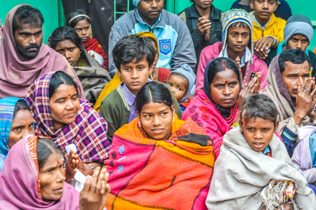 Bohdgaya, Bihar - circa January 2012: Children with their parents pray at school in Bohdgaya, Bihar. Documentary editorial.のeditorial素材