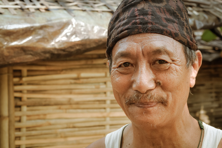 Damak, Nepal - circa May 2012: Native man with brown cap on his head and with moustache at Nepali refugee camp in Damak, Nepal. Documentary editorial.のeditorial素材