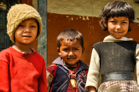Beni, Nepal - circa May 2012: Three young native children pose to photocamera in Beni, Nepal. Documentary editorial.のeditorial素材