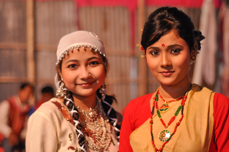 Guwahati, Assam - circa April 2012: Two beautiful young women in traditional clothes smile at Bihu festival in Guwahati, Assam. Documentary editorial.のeditorial素材