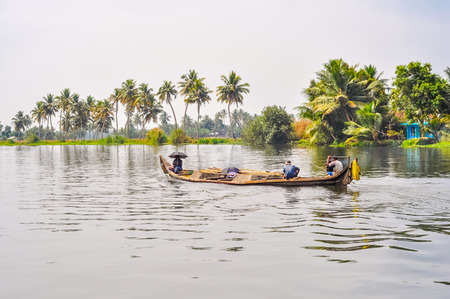 Alleppey Backwaters, Kerala - circa February 2012: Photo of wooden boat with native people in beautiful countryside of Alleppey Backwaters in Kerala. Documentary editorial.のeditorial素材