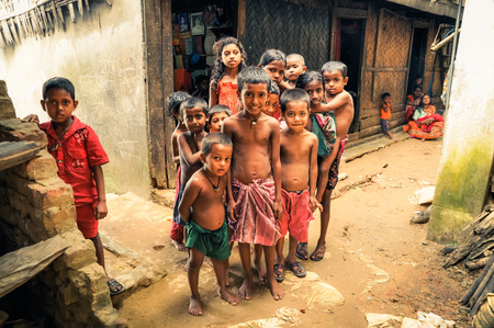 Rangamati, Bangladesh - circa July 2012: Young halfnaked children pose curiously to photocamera in street in Rangamati, Bangladesh. Documentary editorial.のeditorial素材