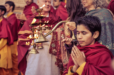 Rishikesh, Uttarakhand - circa December 2011: Young boy with closed eyes and bindi on forehead prays during ceremony in Rishikesh, Uttarakhand. Documentary editorial.のeditorial素材