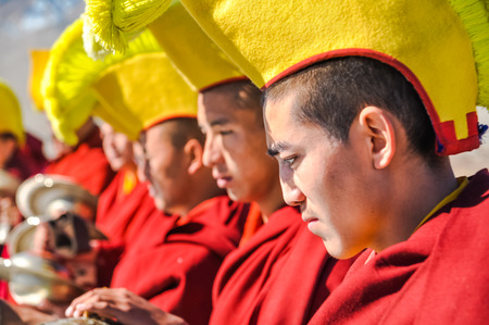 Thiksey, Ladakh - circa November 2011: Photo of monks during festival at Thiksey monastery, Ladakh. They wear traditional big yellow hats on heads. Documentary editorial.のeditorial素材