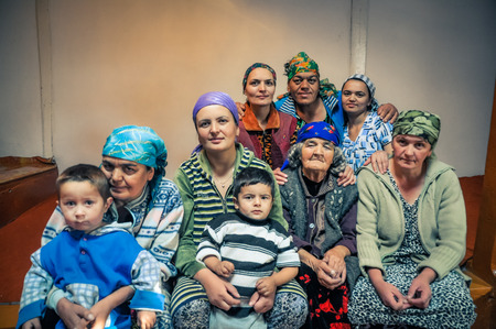Khorog, Tajikistan - circa October 2011: Women of big native family pose with their children in Khorog, Tajikistan. Documentary editorial.のeditorial素材
