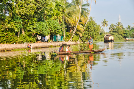 Alleppey Backwaters, Kerala - circa February 2012: Native people sit in boat and sail at Alleppey Backwaters in Kerala. Documentary editorial.のeditorial素材