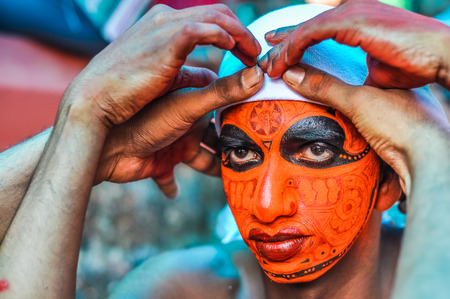 Thottada, south of Kannur, Kerala - circa January 2012: Preparing of costume and mask during Theyyam near Thottada, south of Kannur, Kerala. Documentary editorial.のeditorial素材