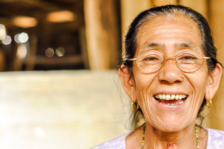 Damak, Nepal - circa May 2012: Native woman with glasses and golden piercing in her nose in Damak, Nepal. Documentary editorial.のeditorial素材