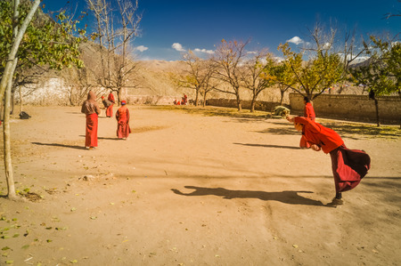 Hemis, Ladakh - circa November 2011: Photo of monks playing cricket at Tibetan Buddhist monastery in Hemis, Ladakh. Documentary editorial.のeditorial素材