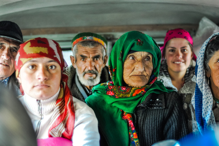 Khorog, Tajikistan - circa September 2011: People sit in car and some of them look to photocamera and smile in Khorog, Tajikistan. Documentary editorial.のeditorial素材