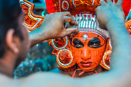 Thottada, south of Kannur, Kerala - circa January 2012: Beautiful mask of young ritual dancer at Theyyam near Thottada, south of Kannur, Kerala. Documentary editorial.のeditorial素材
