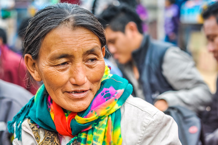 Bohdgaya, Bihar - circa January 2012: Older woman with colourful scarf around her neck poses during...